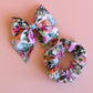 Pink and multicolour floral mum, baby and sister matching accessory set with hair bow and scrunchie