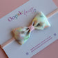 Pastel floral patterned hair bow on baby headband
