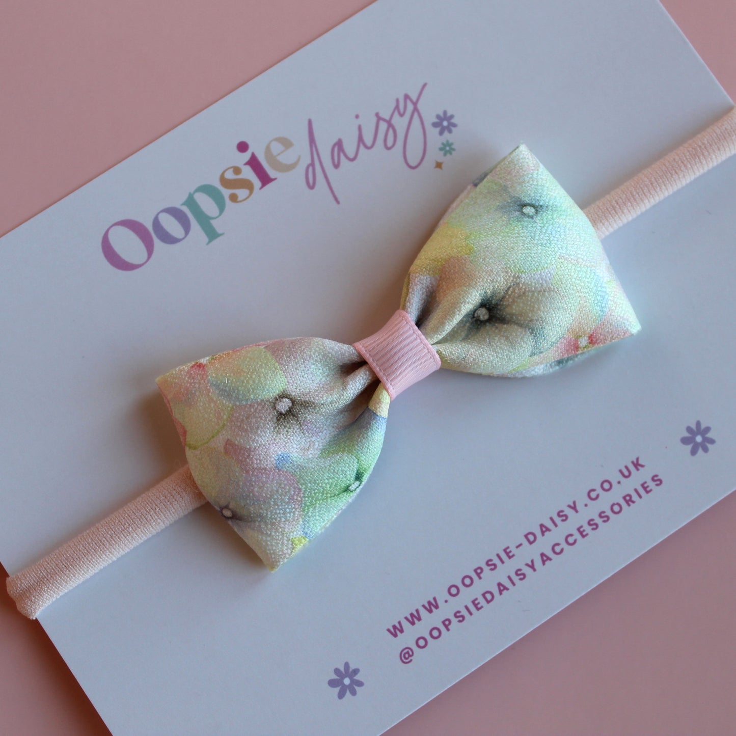 Pastel floral patterned hair bow on baby headband