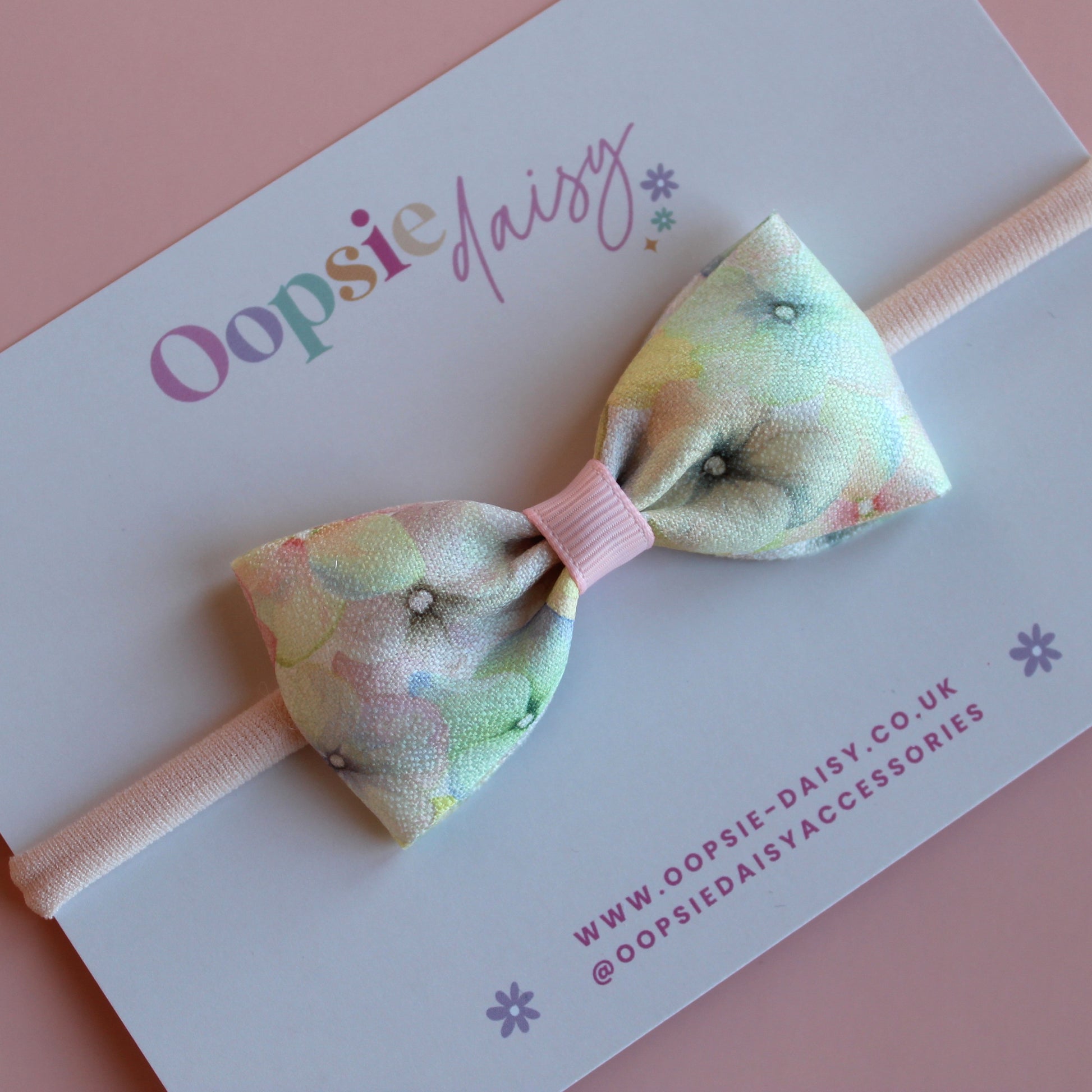 Pastel floral patterned hair bow on baby headband