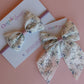 Cream hair bow gift set with little muted mauve-purple flowers