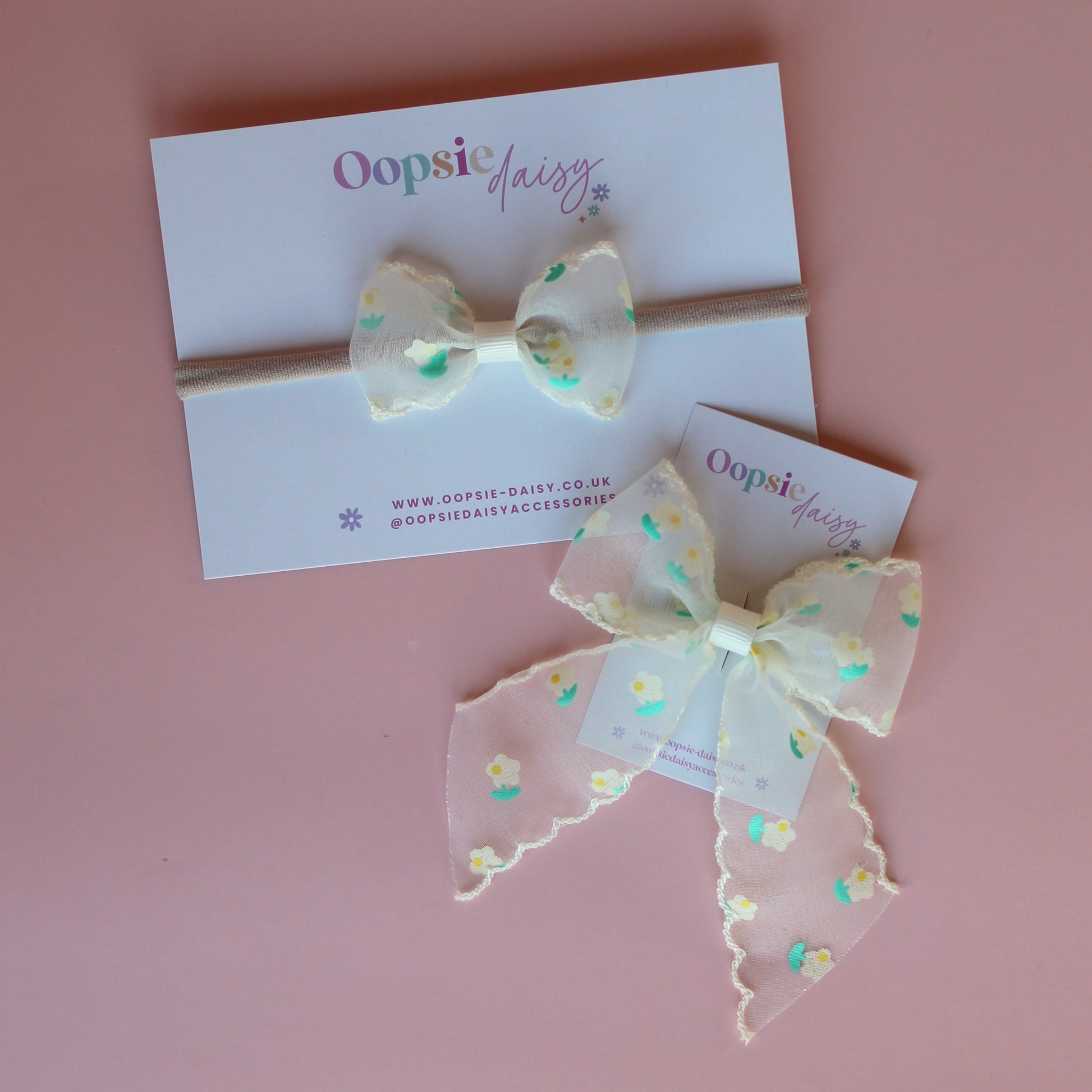 Gift set of baby headband and hair bow with cream sheer fabric with small dainty cream and green flowers.