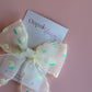 Sheer cream hair bow with dainty yellow-cream and green flowers