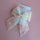 Sheer cream hair bow with dainty yellow-cream and green flowers