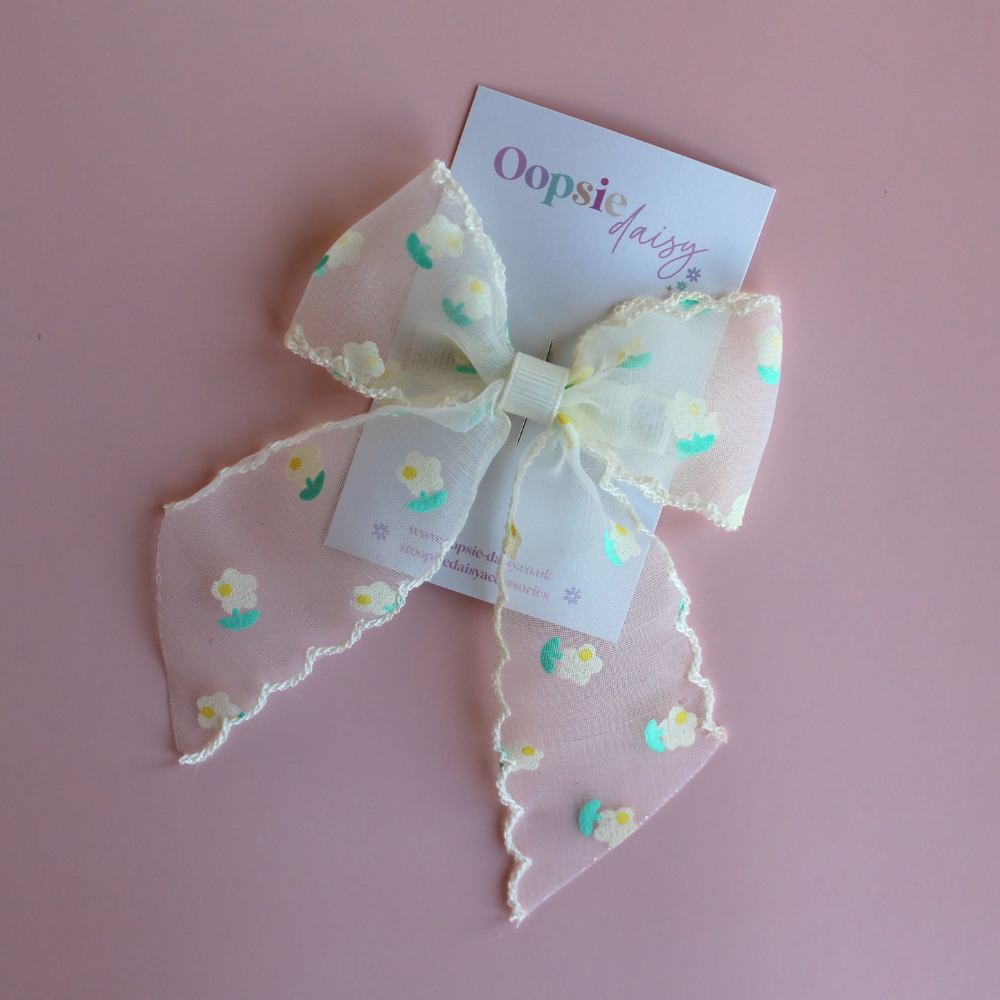Sheer cream hair bow with dainty yellow-cream and green flowers