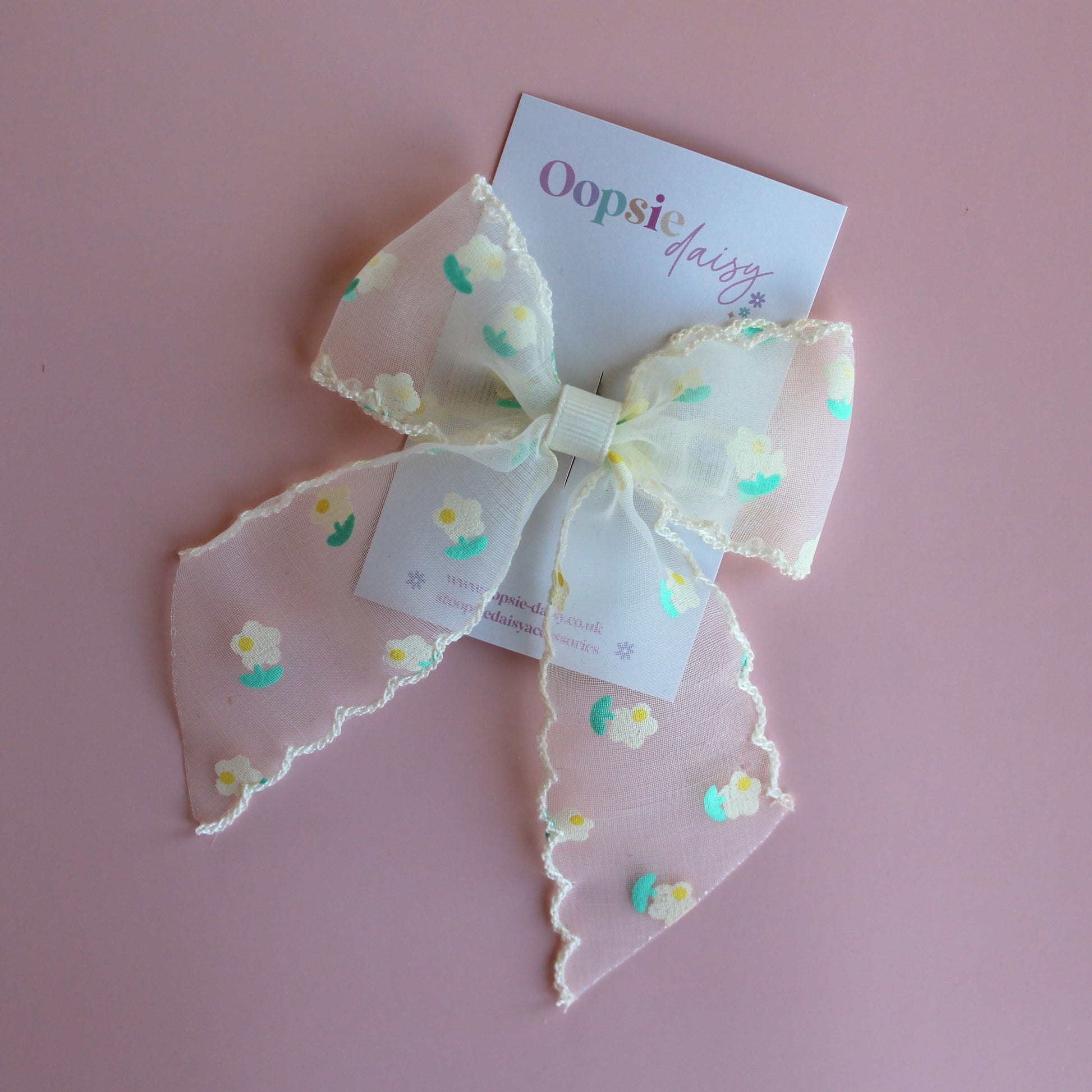 Sheer cream hair bow with dainty yellow-cream and green flowers