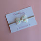 Sheer cream bow on baby headband with dainty yellow-cream and green flowers