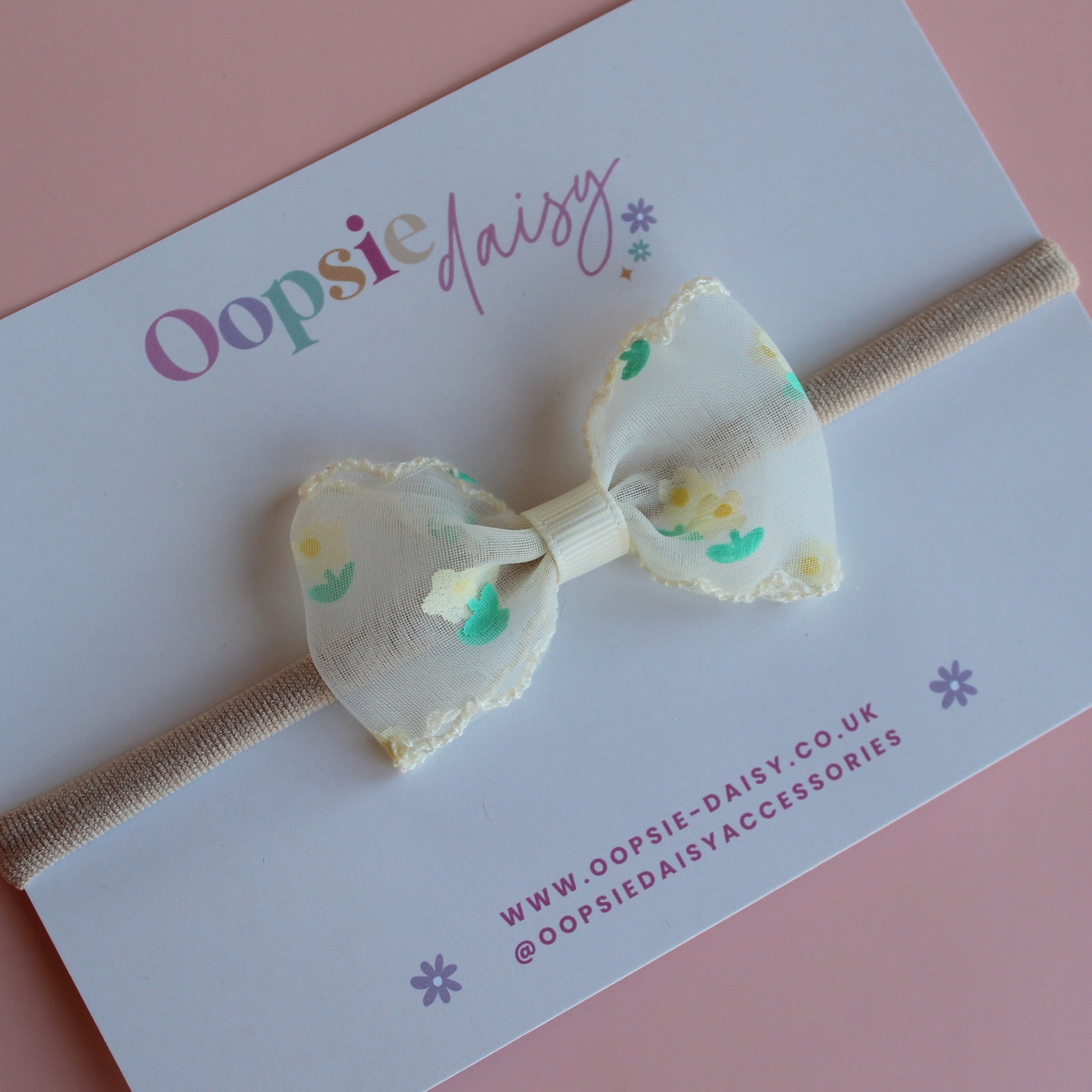 Sheer cream bow on baby headband with dainty yellow-cream and green flowers
