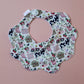 Scallop baby bib with girls farm themed pattern. Cream background with cows, pink watering cans, tractors and strawberries.