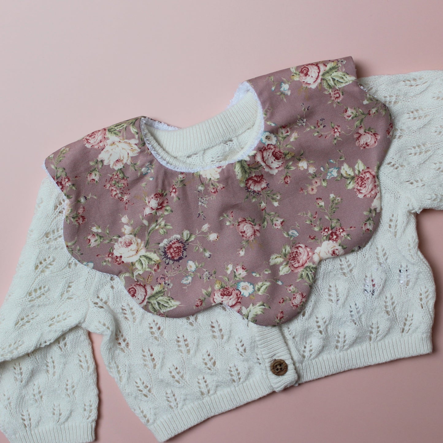 Scallop baby bib in dark pink with vintage floral pink pattern