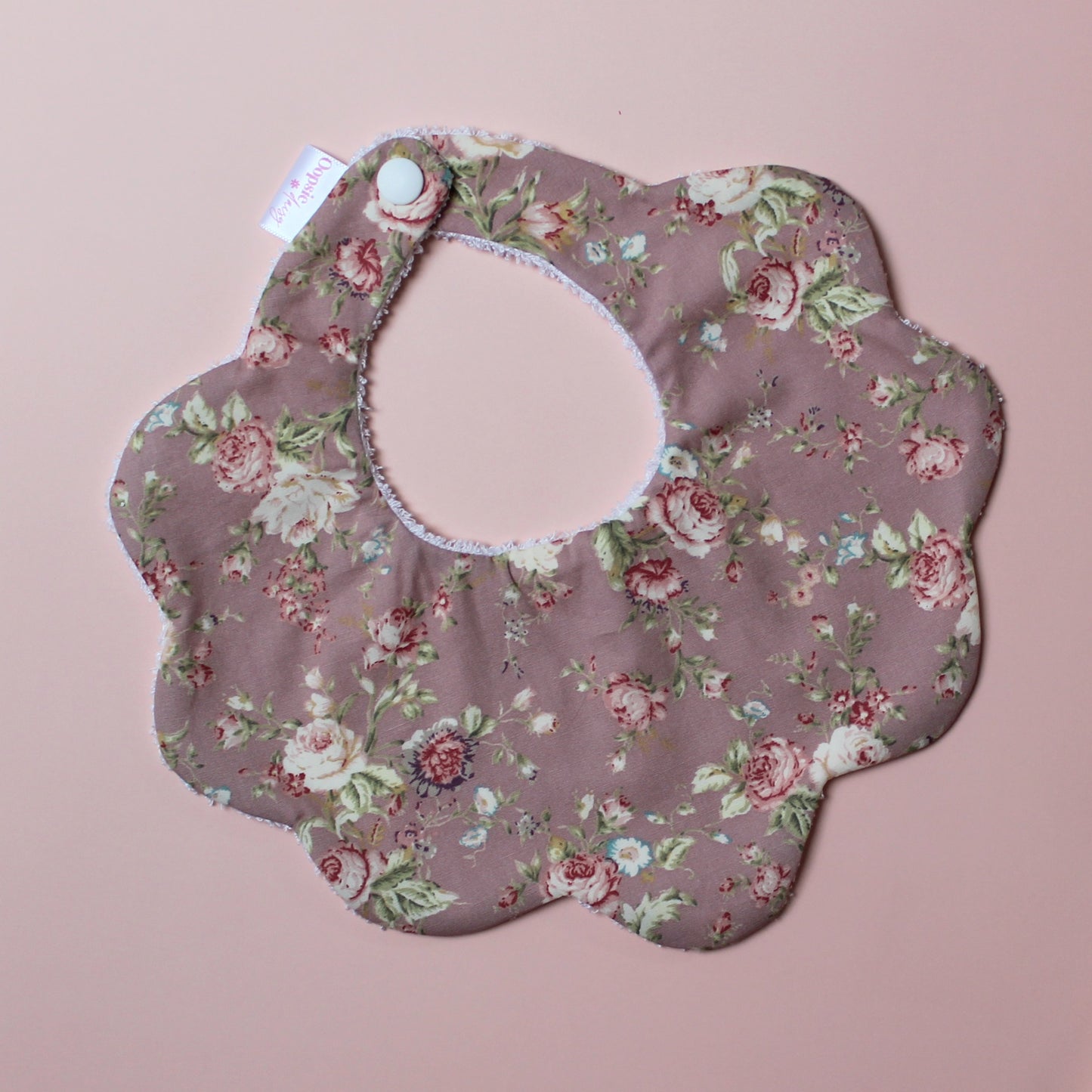 Scallop baby bib in dark pink with vintage floral pink pattern
