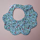 Blue scallop baby bib with ditsy floral pattern