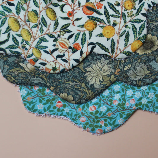 Set of 3 scallop shaped baby bibs in William Morris inspired designs