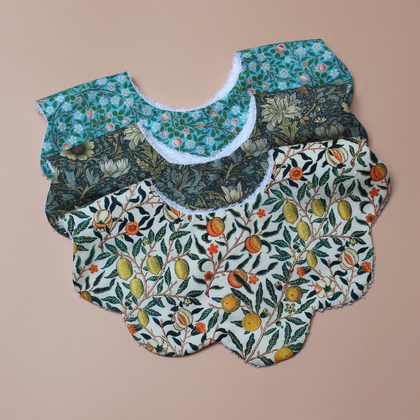 Set of 3 scallop shaped baby bibs in William Morris inspired designs