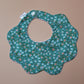 Scallop baby bib in teal with small ditsy flowers