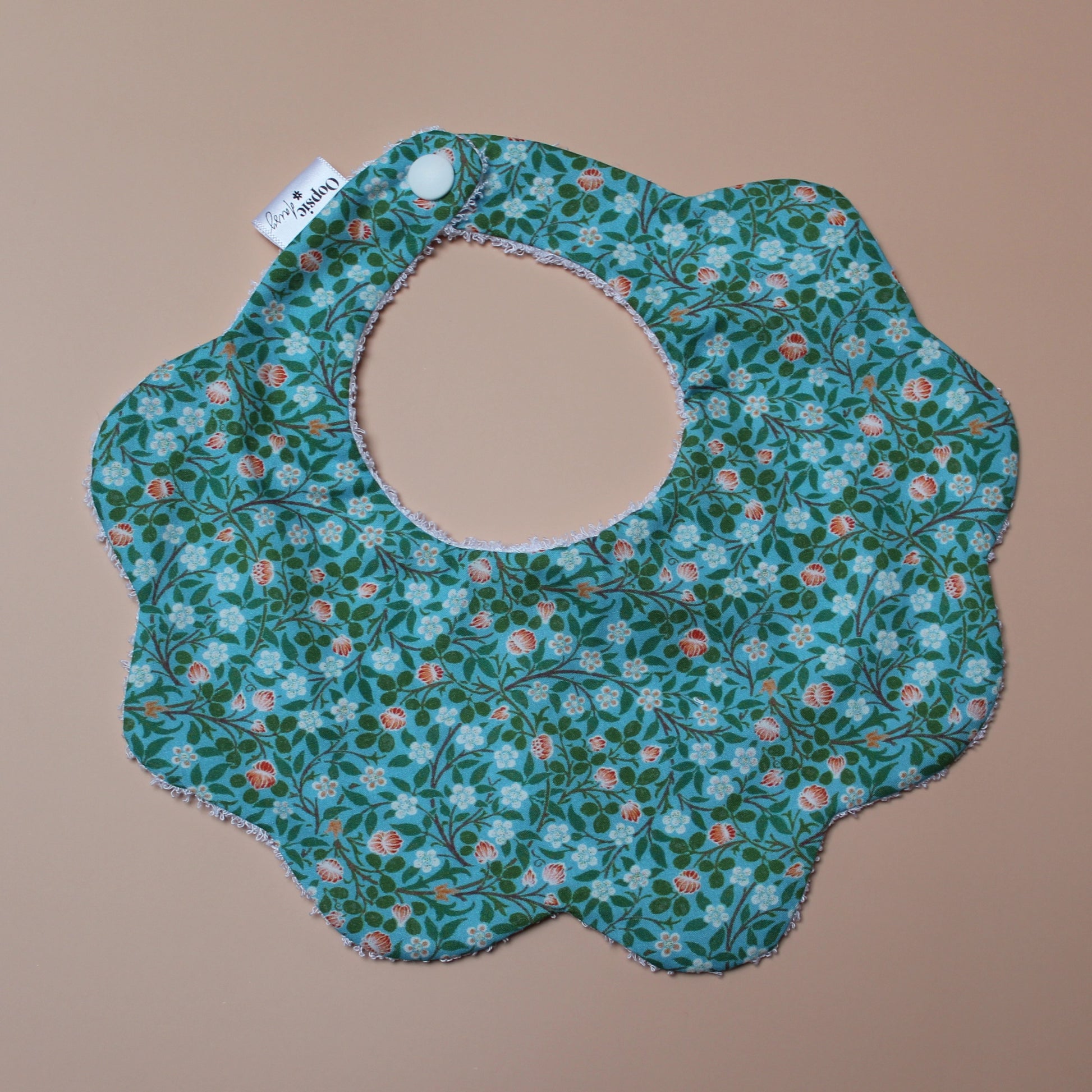 Scallop baby bib in teal with small ditsy flowers