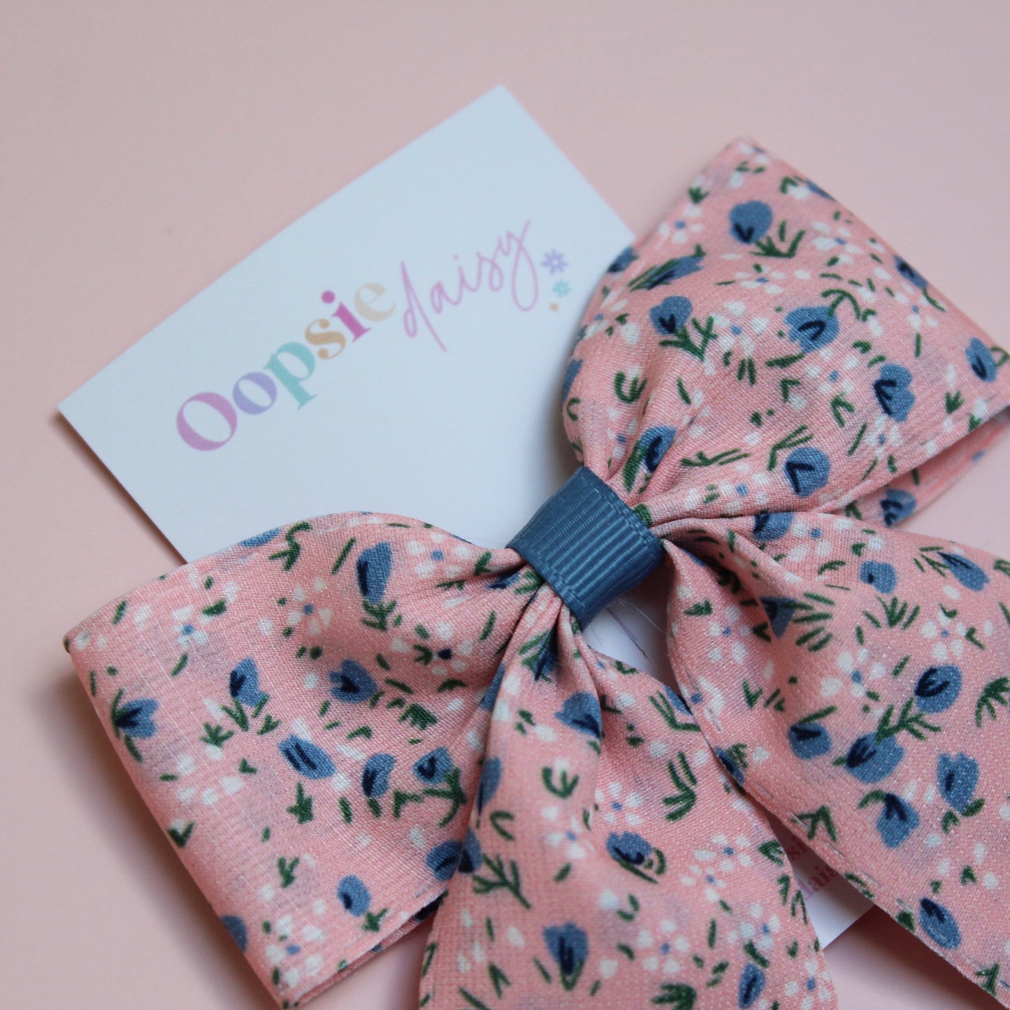 Pink hair bow with ditsy blue flowers
