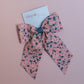 Pink hair bow with ditsy blue flowers