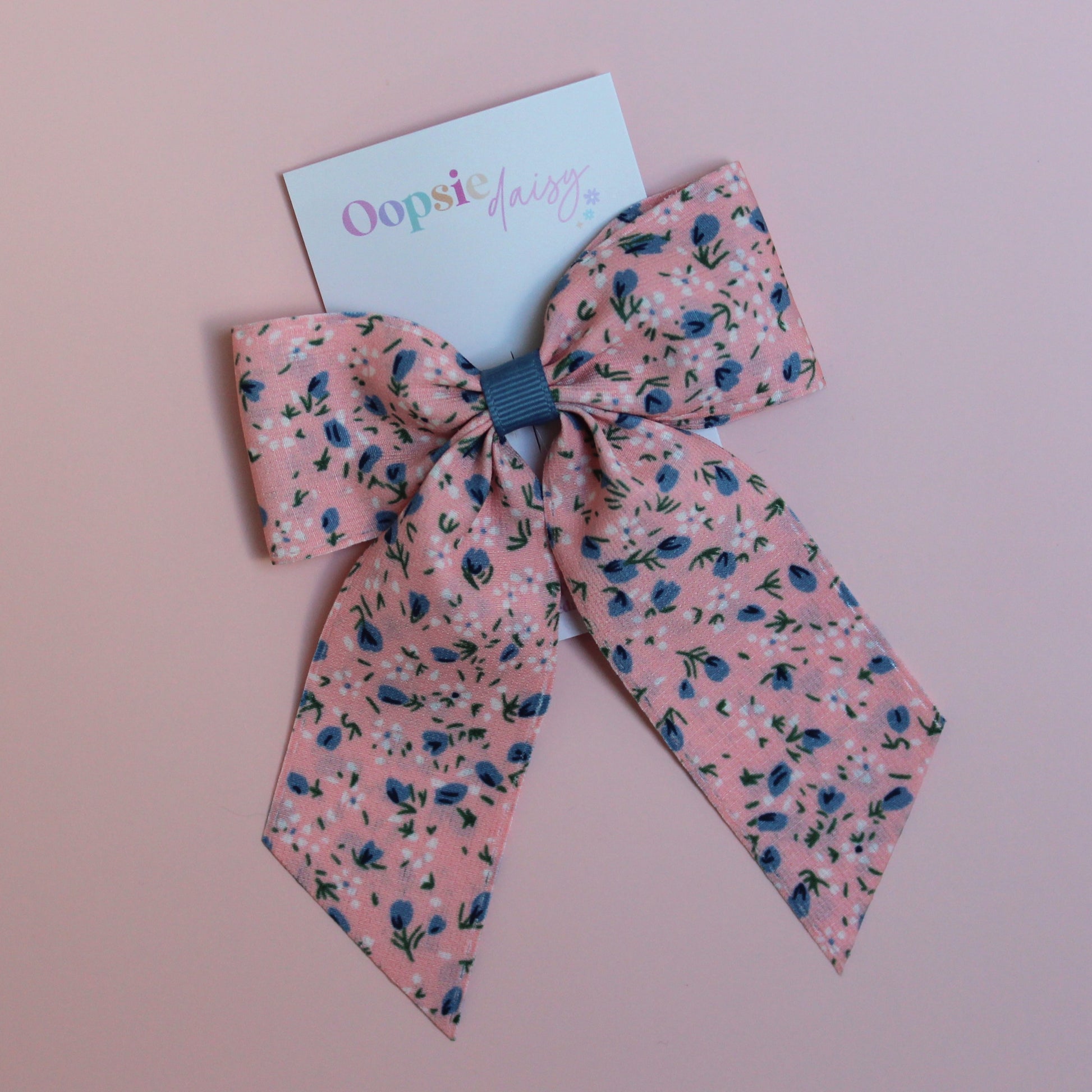 Pink hair bow with ditsy blue flowers