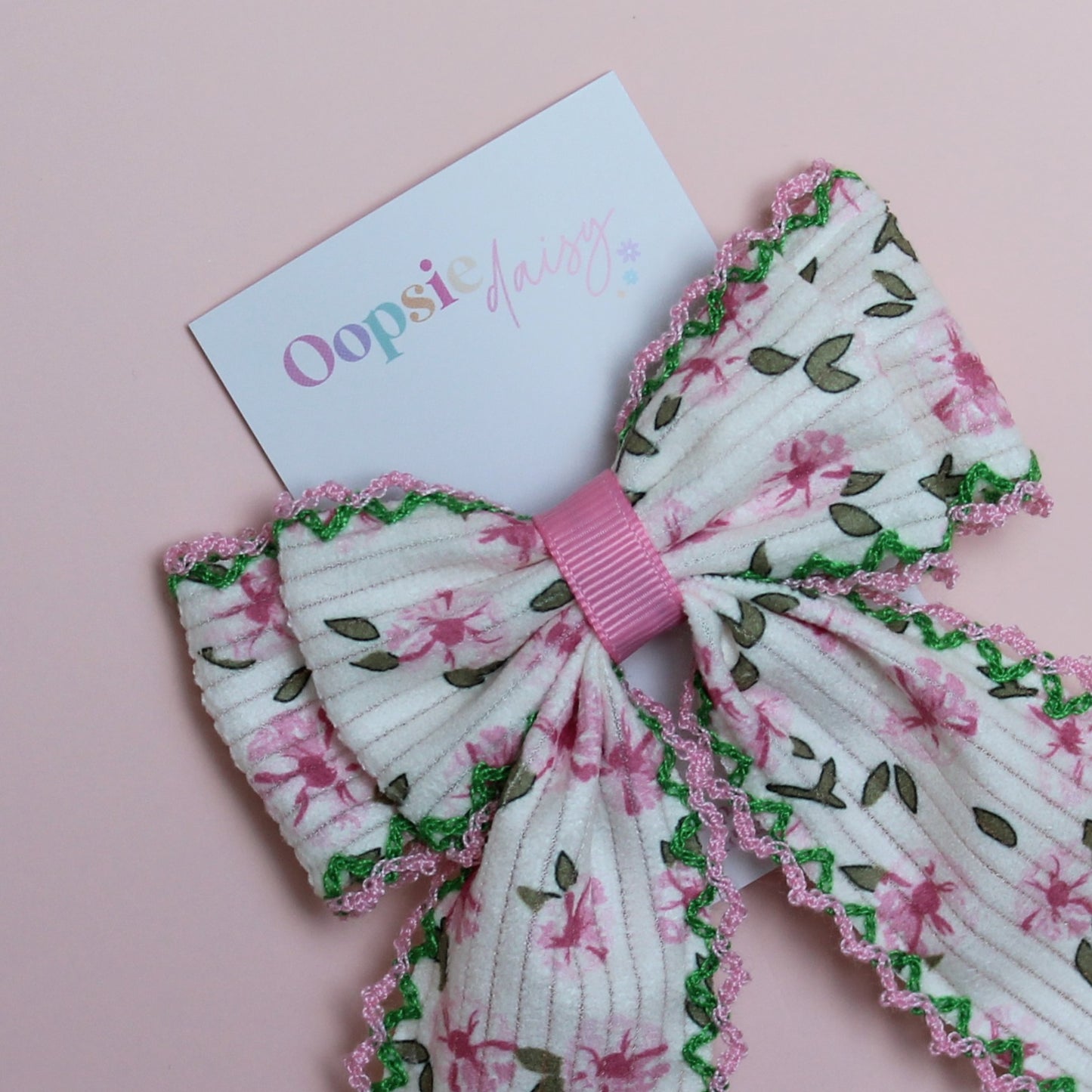 Cream hair bow with pink flowers and pink and green edges