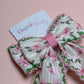 Cream hair bow with pink flowers and pink and green edges