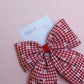 red and white gingham hair bow with flowers