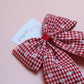 red and white gingham hair bow with flowers