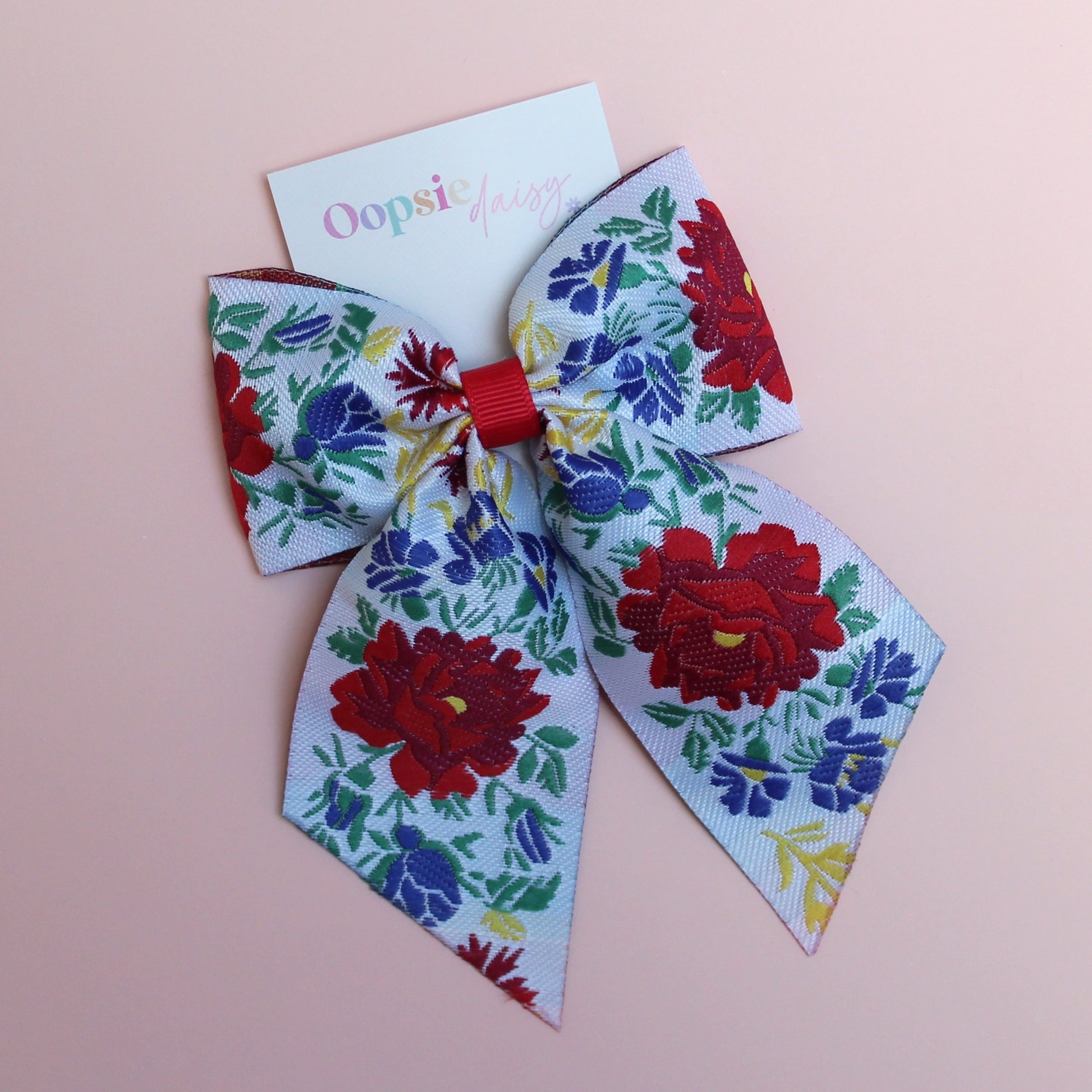 Floral patterned hair bow with red and blue flowers