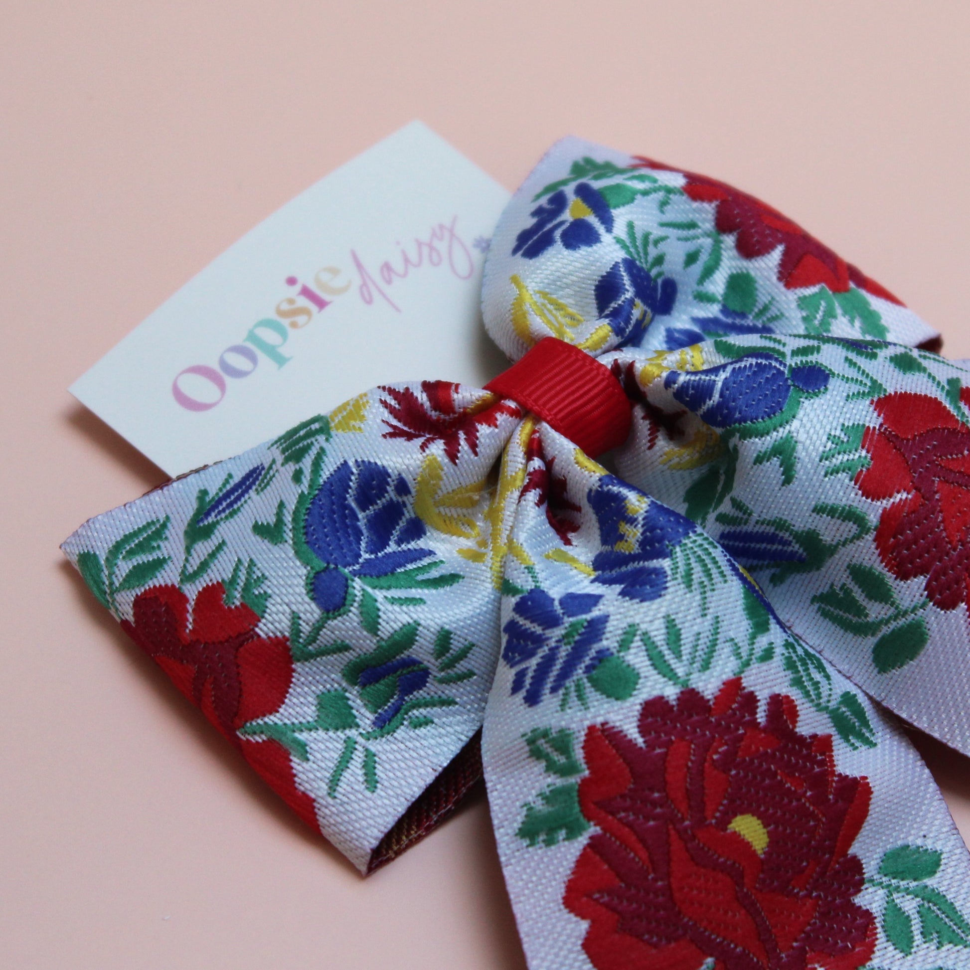 Floral patterned hair bow with red and blue flowers