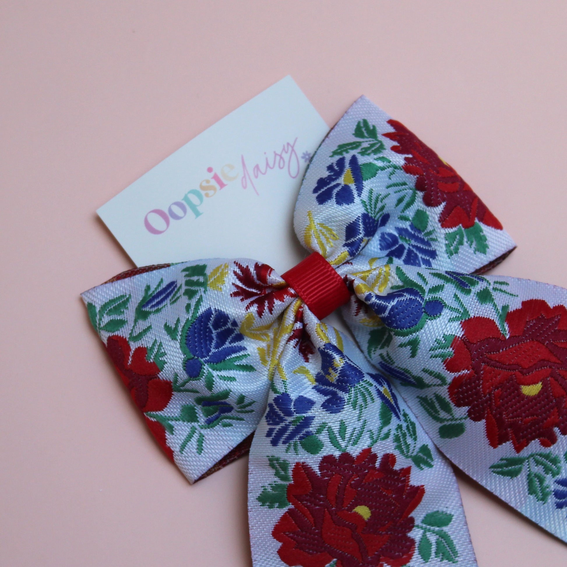 Floral patterned hair bow with red and blue flowers