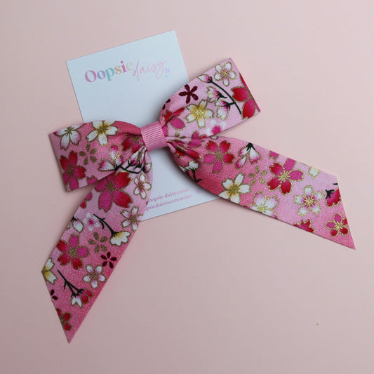 Pink and white ombre hair bow with flowers edged in gold shimmer 