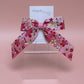 Pink and white ombre hair bow with flowers edged in gold shimmer 