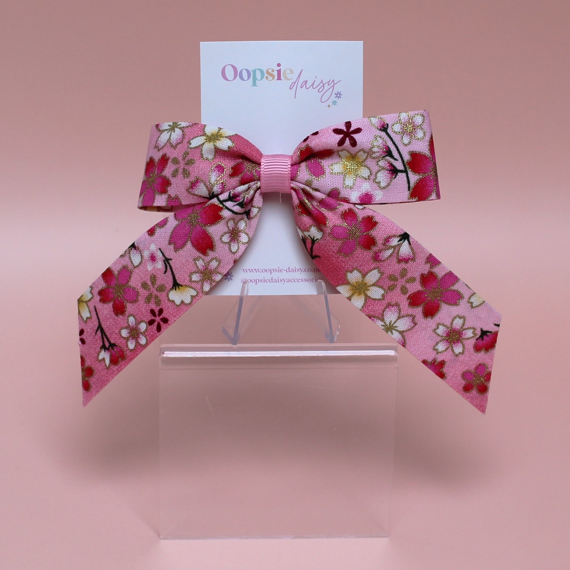 Pink and white ombre hair bow with flowers edged in gold shimmer 