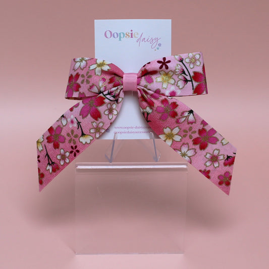 Pink and white ombre hair bow with flowers edged in gold shimmer 