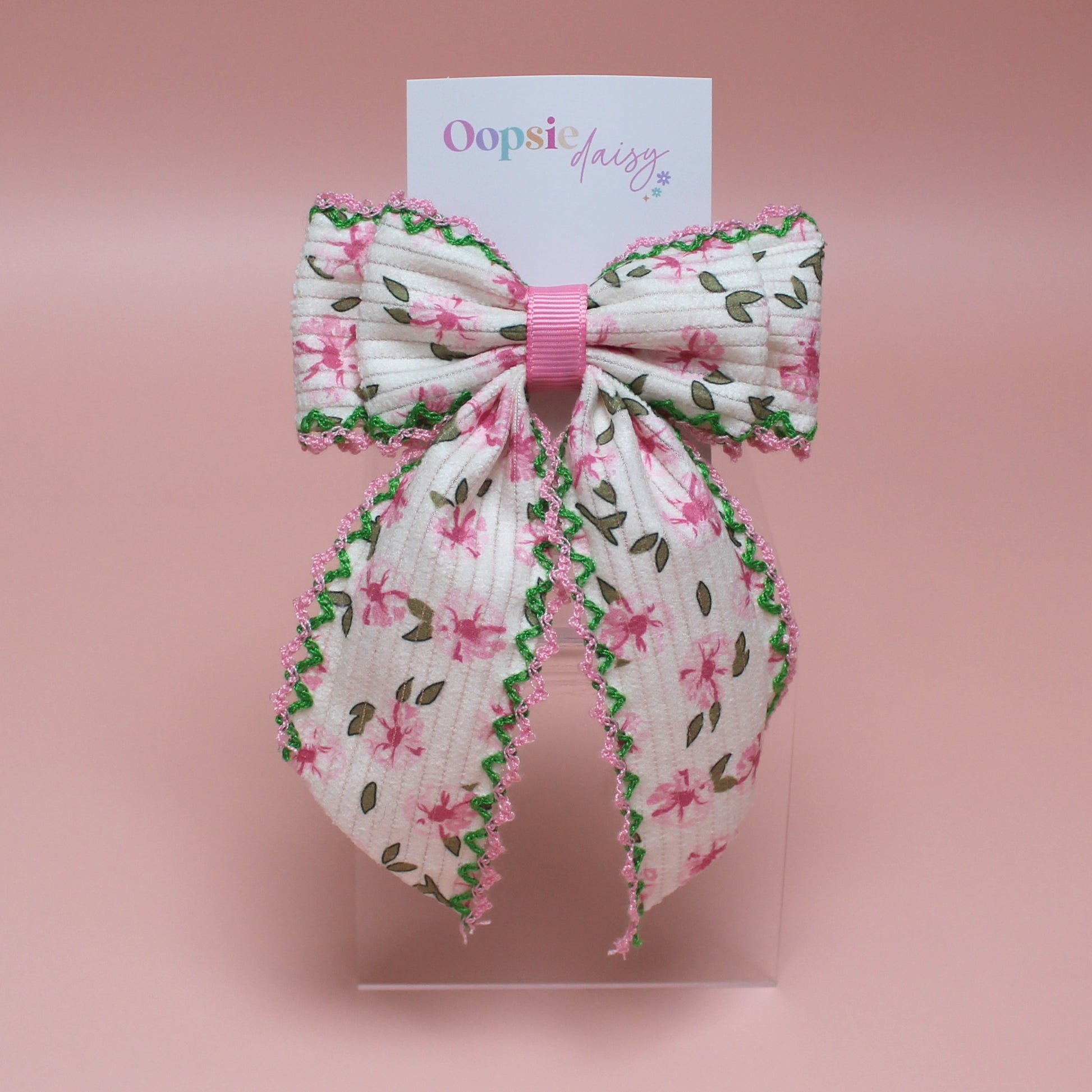 Cream hair bow with pink flowers and pink and green edges