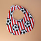 Red and white striped football baby bib