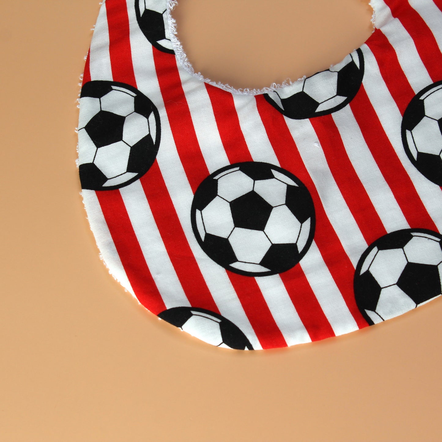 Red and white striped football baby bib