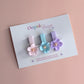 Set of 3 hair clips with pastel flowers in blue, pink and purple