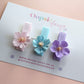 Set of 3 hair clips with pastel flowers in blue, pink and purple