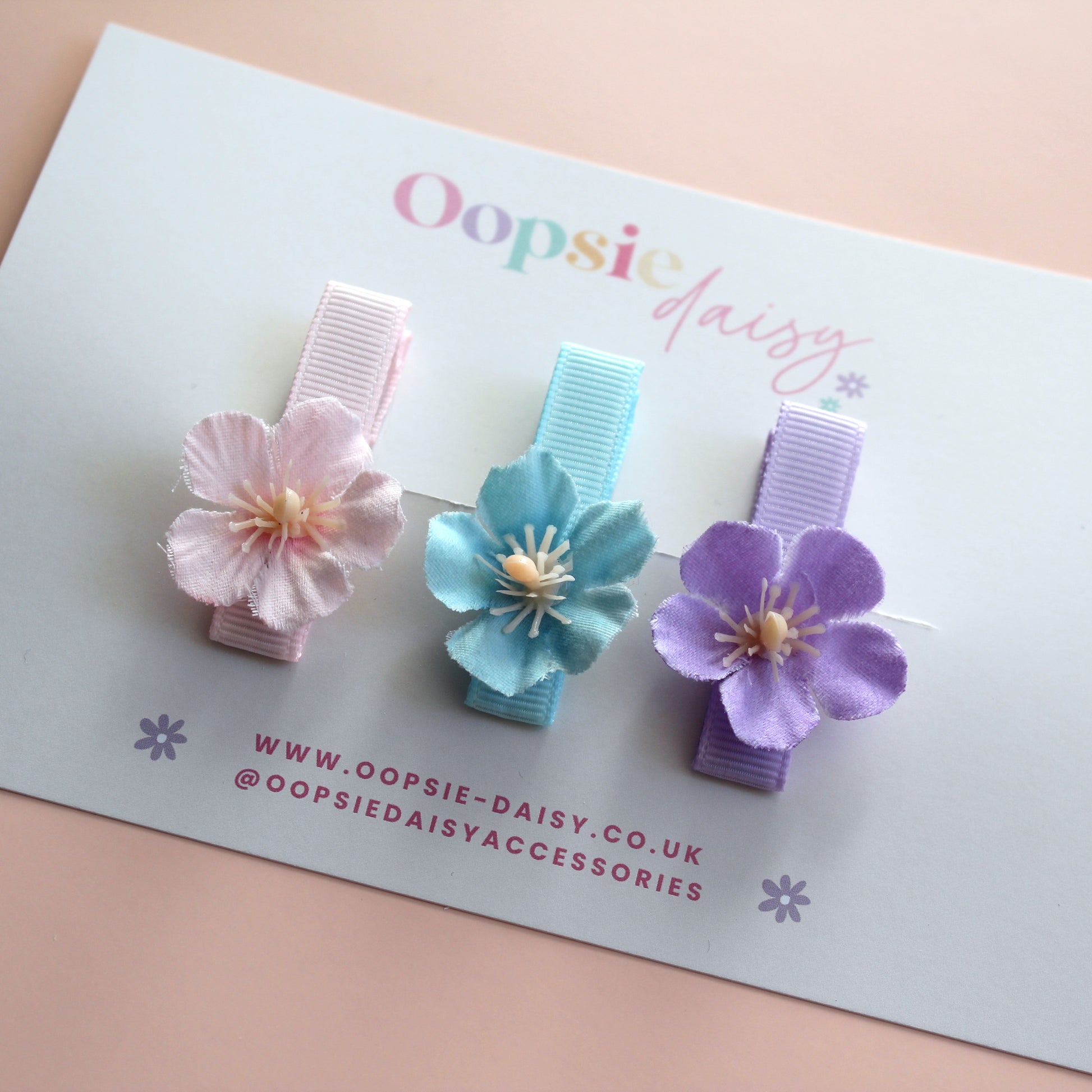 Set of 3 hair clips with pastel flowers in blue, pink and purple