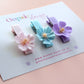 Set of 3 hair clips with pastel flowers in blue, pink and purple