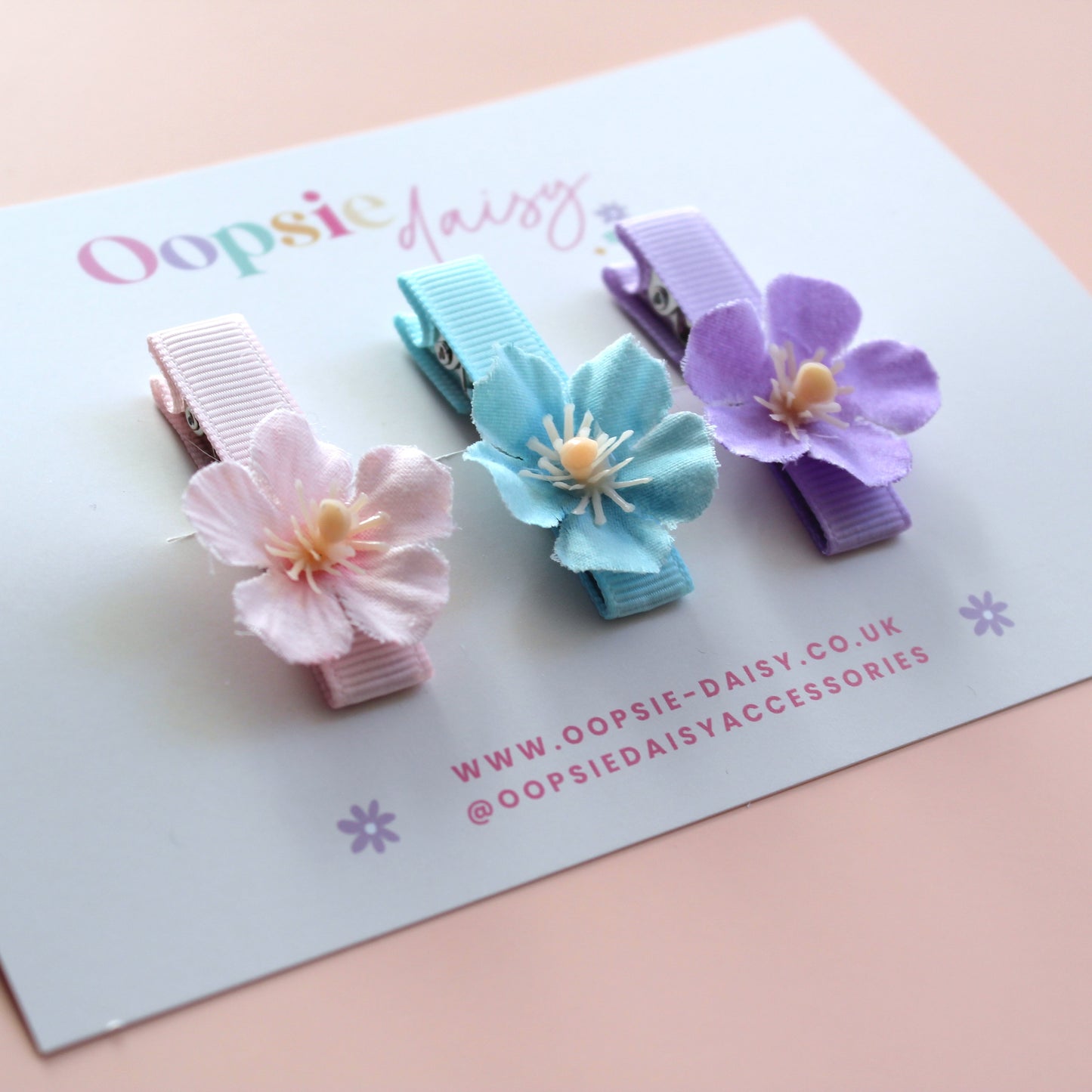 Set of 3 hair clips with pastel flowers in blue, pink and purple