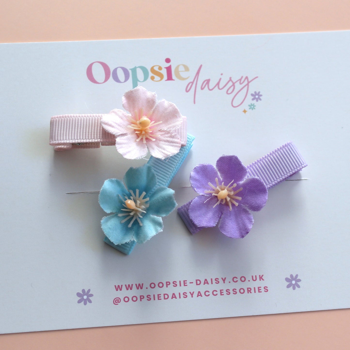 Set of 3 hair clips with pastel flowers in blue, pink and purple
