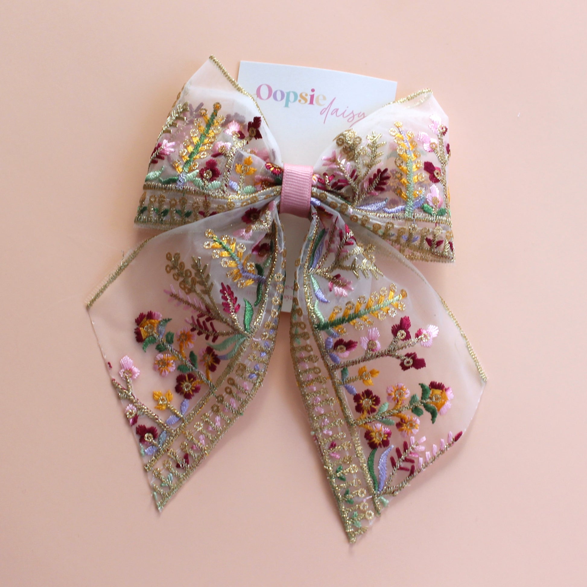 Transparent hair bow with colourful burgundy and gold embroidered floral pattern