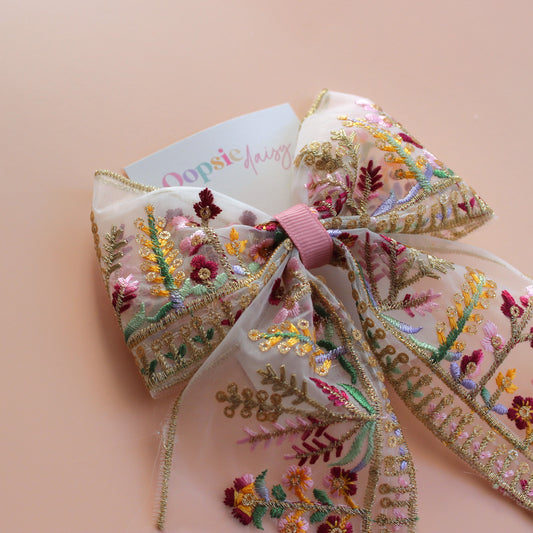 Transparent hair bow with colourful burgundy and gold embroidered floral pattern