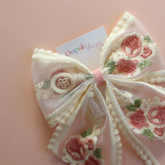Sheer lace hair bow with cream and pink embroidered flowers