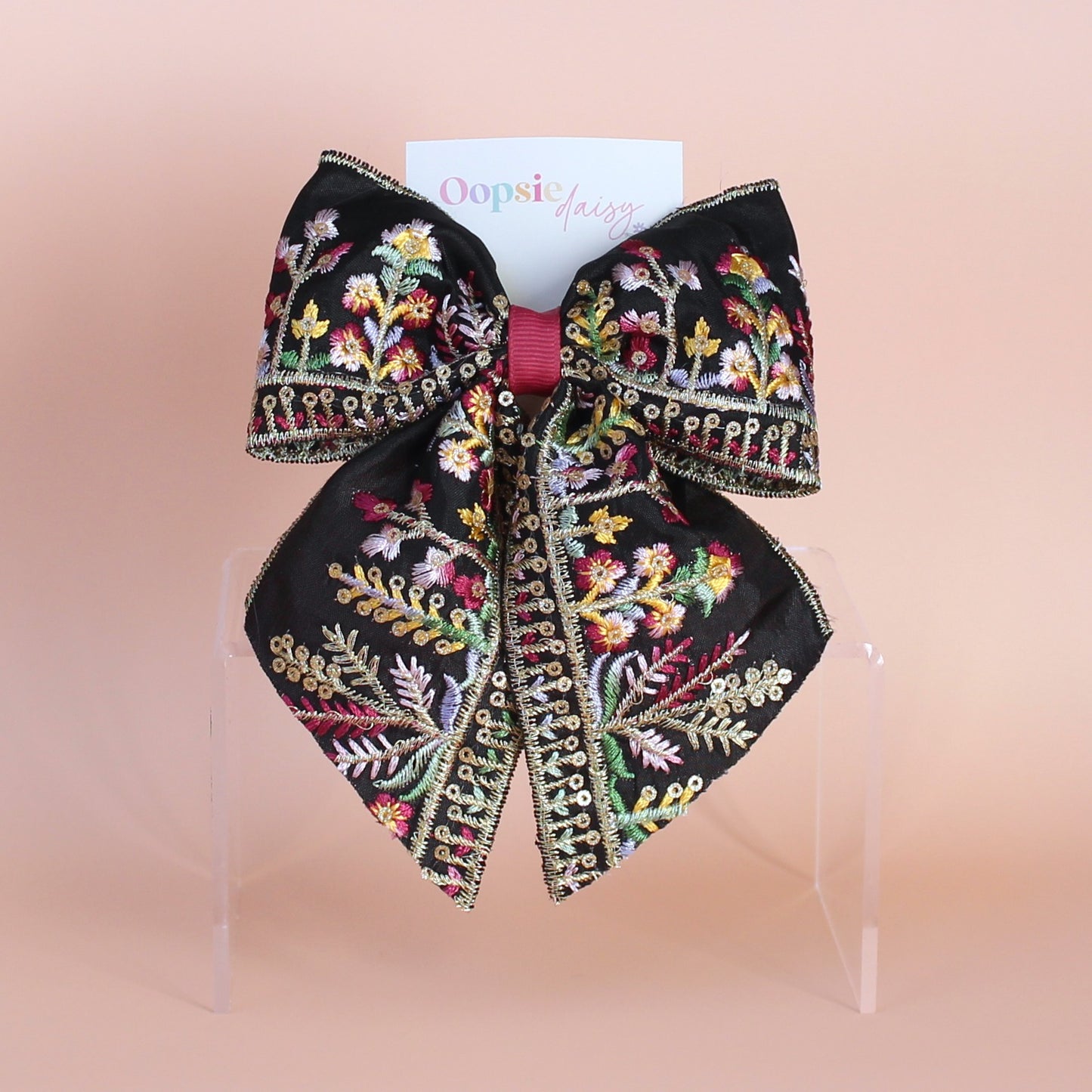 Black hair bow with colourful burgundy and gold embroidered floral pattern