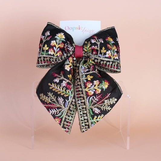 Black hair bow with colourful burgundy and gold embroidered floral pattern