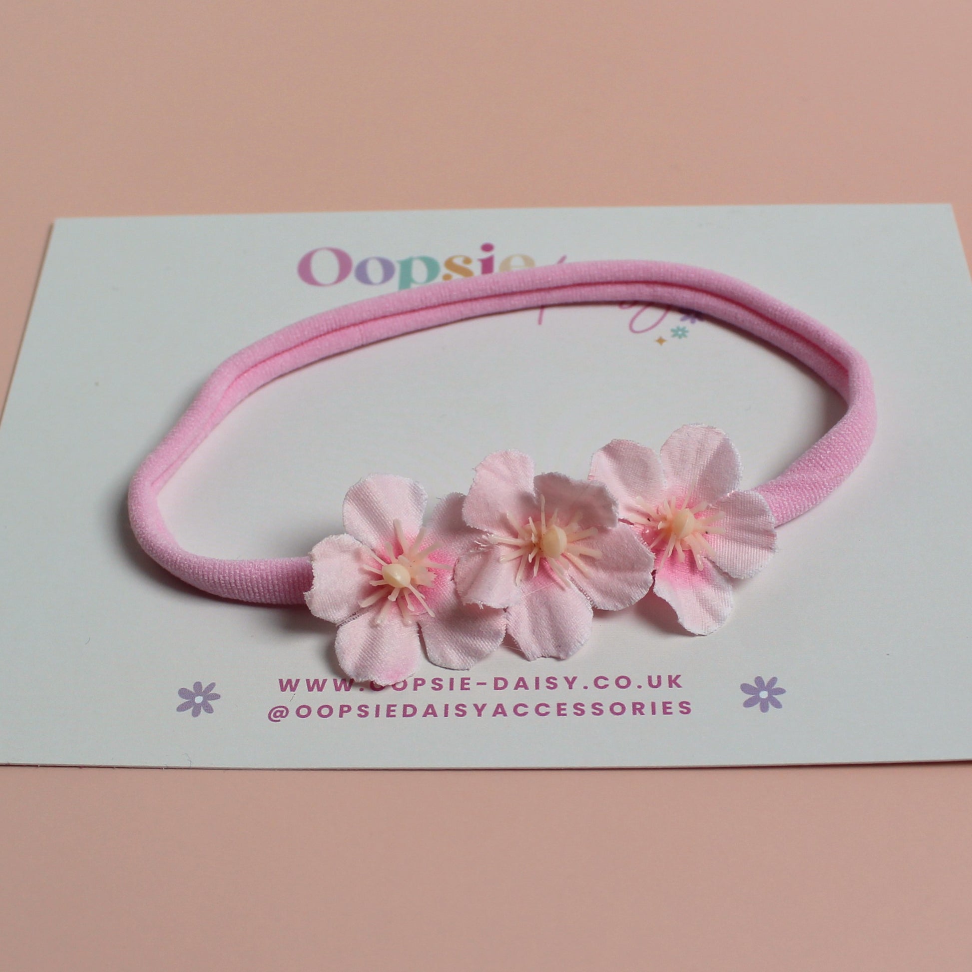 Pink baby headband with 3 pink flowers