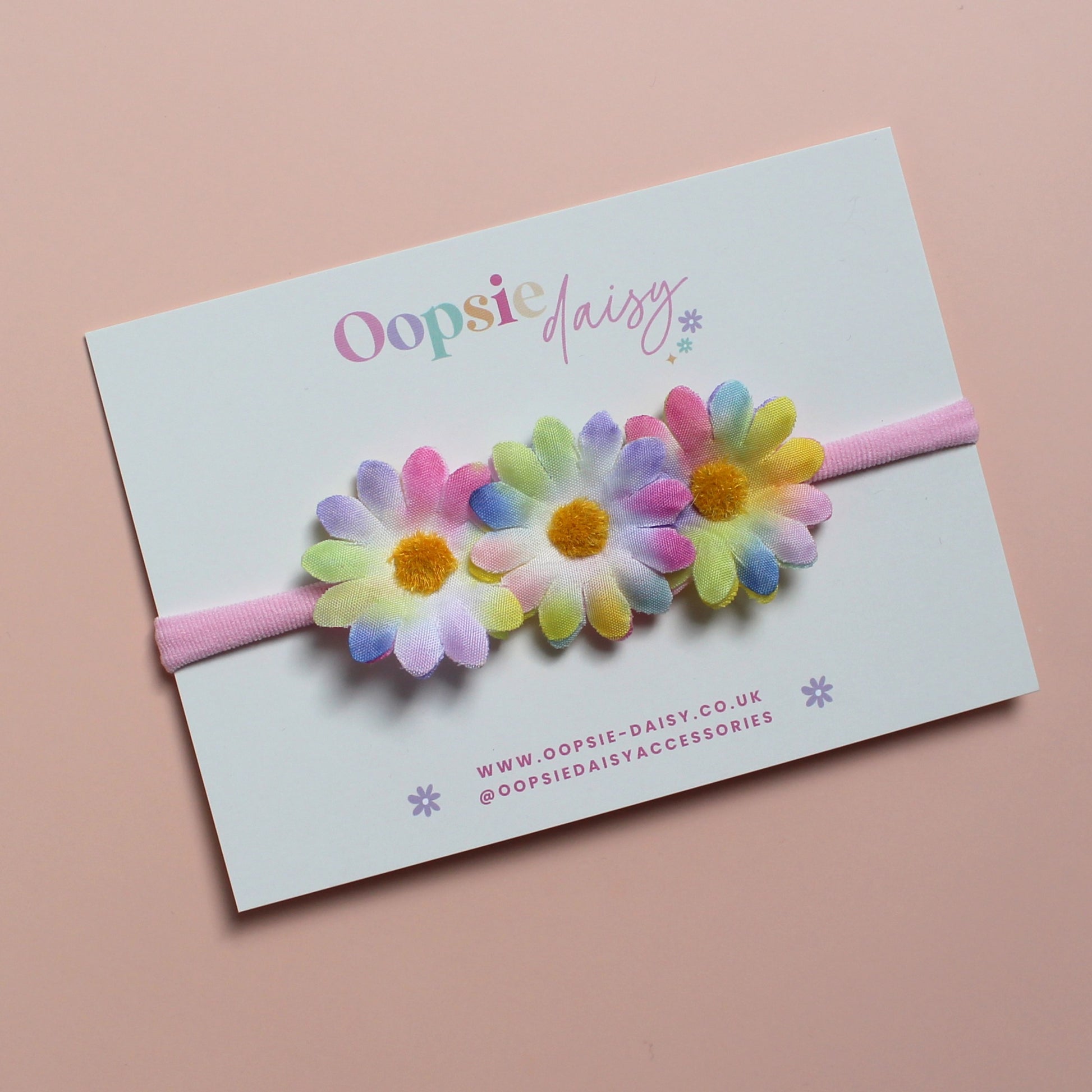 Pink baby headband with 3 multicolour daisy flowers